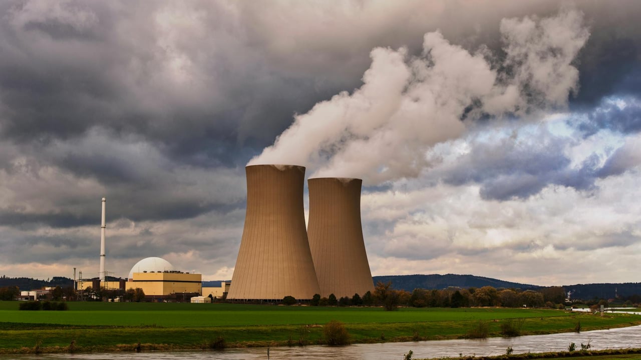 Scenic view of a nuclear power plant with cooling towers emitting steam in Hameln, Germany.