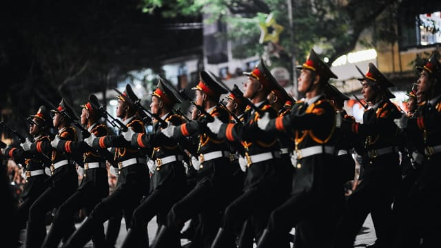 Nighttime military parade through the streets of Hanoi, Vietnam.