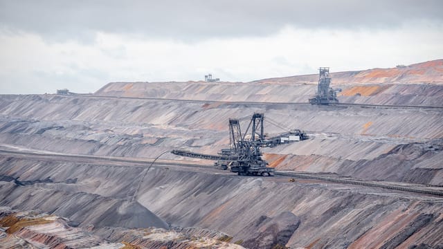 Aerial view of bucket-wheel excavators in an expansive open-pit coal mine.