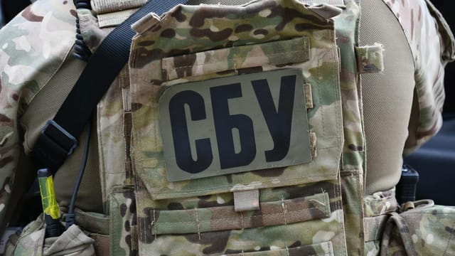 Close-up of a soldier wearing a camouflage vest with the Security Service of Ukraine insignia in Kyiv.