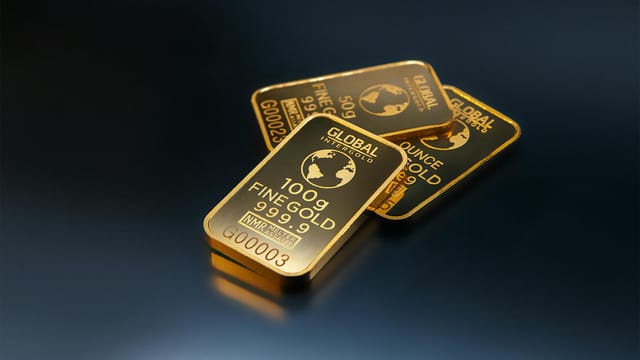 Close-up of gold bars on a dark background, representing wealth and investment opportunities.