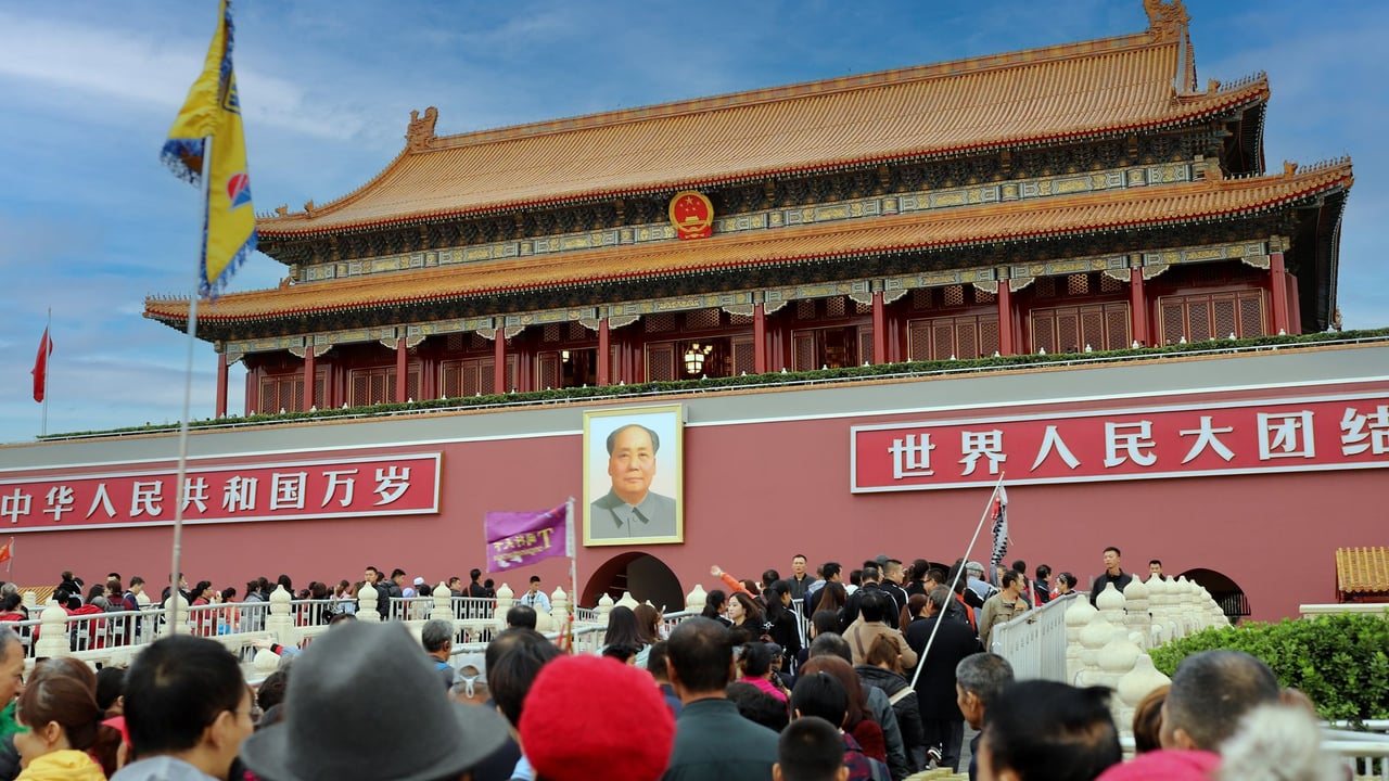 A large crowd gathers at the historic Tiananmen Gate in Beijing, China, showcasing Chinese architecture and culture.