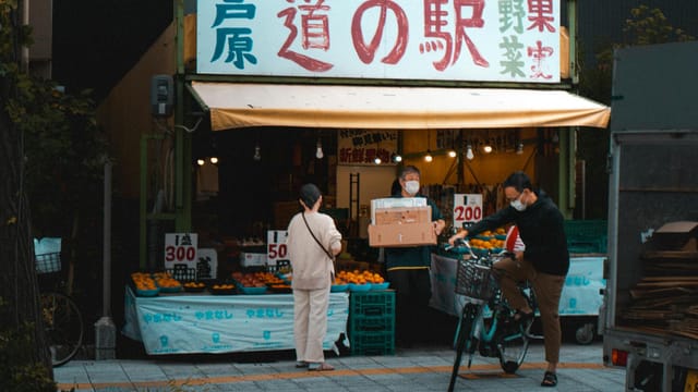 Explore a bustling market street in Kyoto, showcasing local vendors and fresh produce.