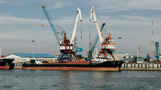 Cargo ships and cranes at the industrial port in Rasht, Gilan Province, Iran.