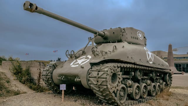 A WWII Sherman tank displayed in Normandy, France, significant for historical tours.