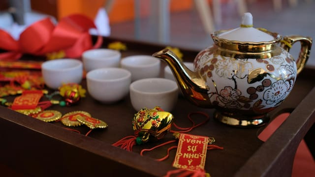 Beautiful Chinese tea ceremony setup featuring ornate porcelain teapot and cups.