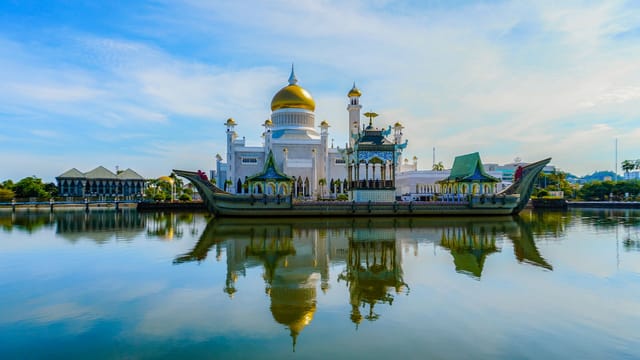 Stunning view of Omar Ali Saifuddien Mosque with its reflection on calm waters in Brunei.