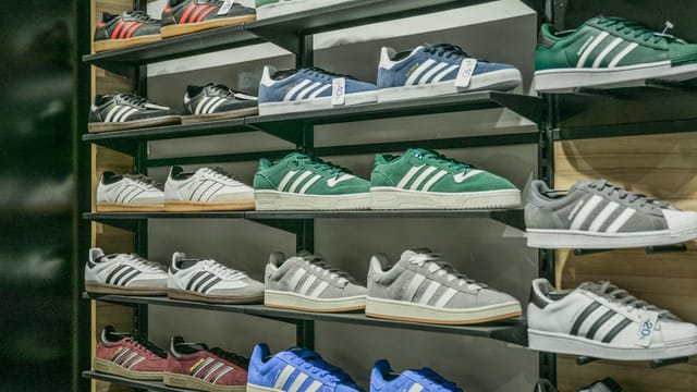 Colorful sneakers arranged on store shelves showcasing trendy footwear options.