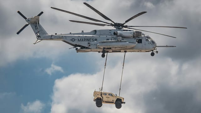 Sikorsky CH-53E Super Stallion airlifting a military vehicle in San Diego.