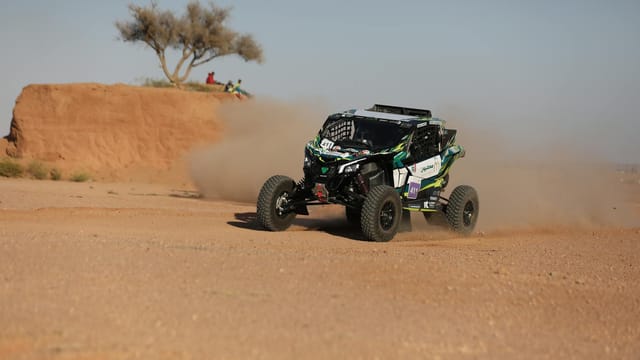 Action-packed off-road rally car racing through the Saudi Arabian desert.