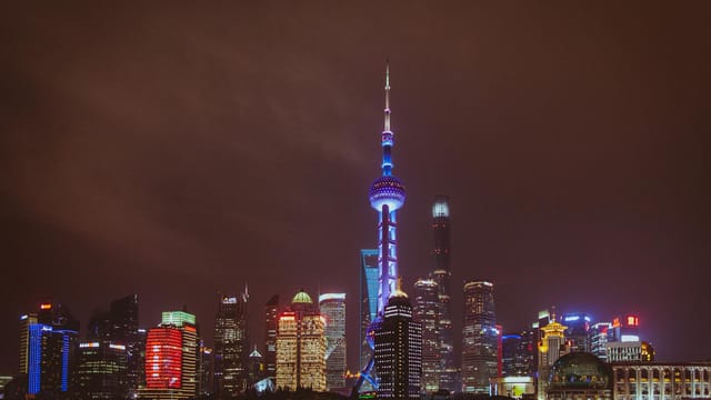 Breathtaking view of Shanghai's illuminated skyline featuring the iconic Oriental Pearl Tower at night.