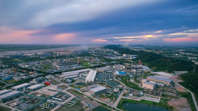 A stunning aerial view of an industrial area at sunset in Jiujiang, China.