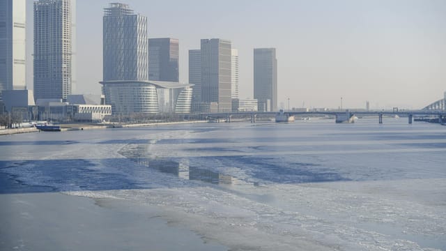 Modern skyscrapers and bridge view of Tianjin by the Haihe River.