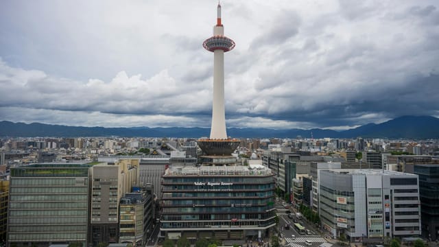Explore the iconic Kyoto Tower surrounded by scenic urban landscapes in the heart of Kyoto, Japan.
