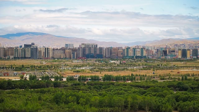 Panoramic view of Ulaanbaatar with greenery and mountains in Mongolia.