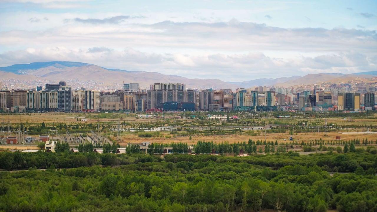 Panoramic view of Ulaanbaatar with greenery and mountains in Mongolia.