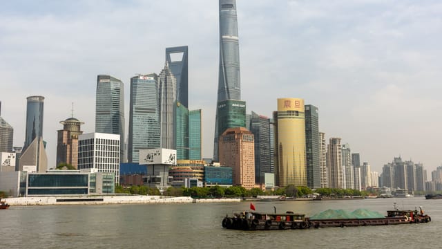 Illustrative image: Dynamic view of Lujiazui's iconic skyscrapers along Huangpu River in Shanghai, China.