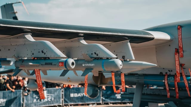 Detailed view of armaments on a Turkish military aircraft displayed at an air show.