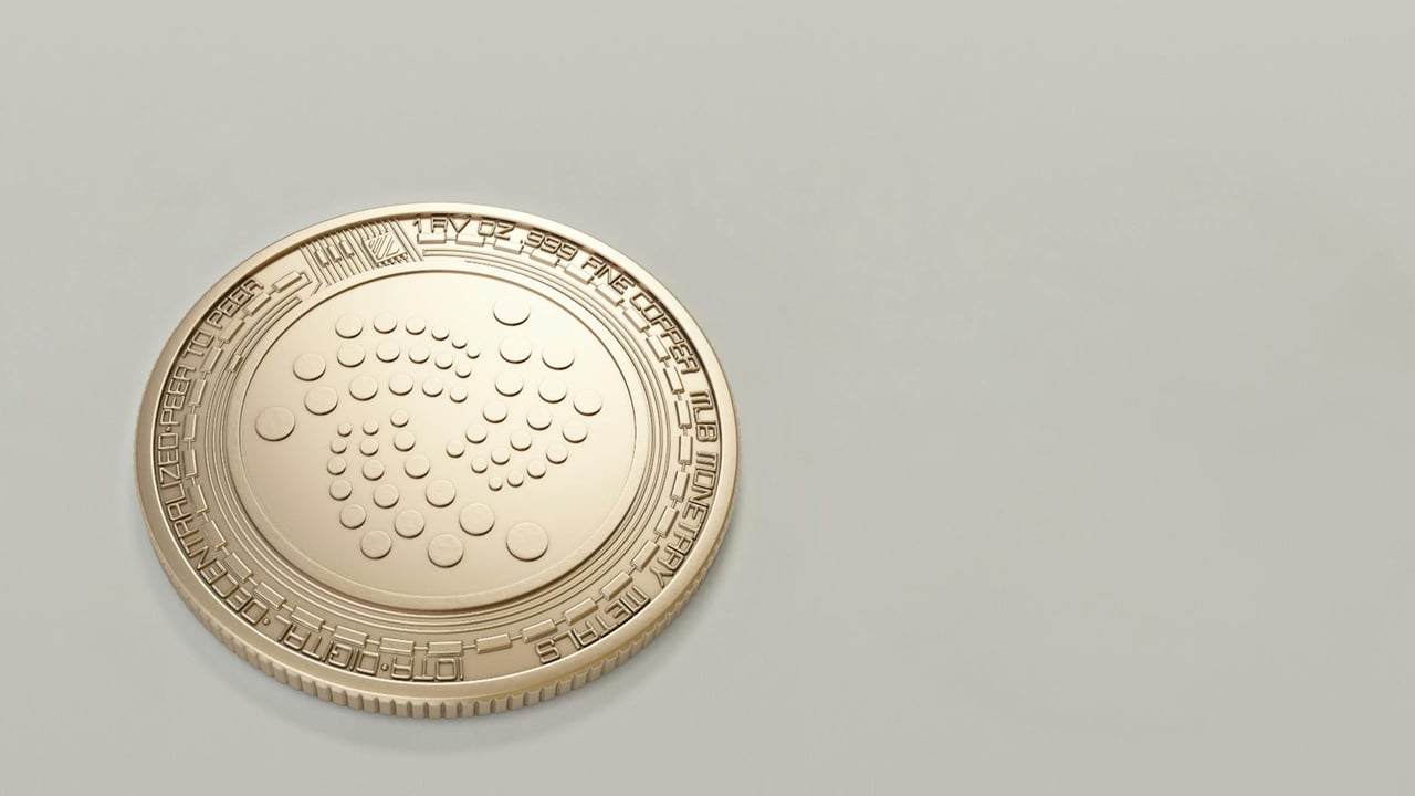 High-quality image of a gold IOTA cryptocurrency coin on a plain background, ideal for finance concepts.