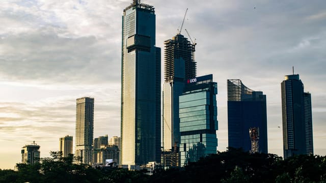 A breathtaking view of modern skyscrapers against a dramatic dusk sky, showcasing urban architecture.