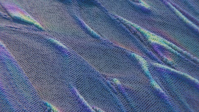 Colorful abstract pattern resembling digital waves with intricate texture in blue and purple hues.