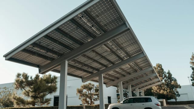 Solar panel carport in a modern urban setting, showcasing clean energy solutions.
