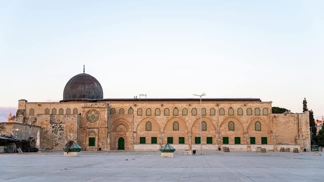 Stunning view of Al-Aqsa Mosque facade during sunset in Jerusalem, emphasizing its architecture.