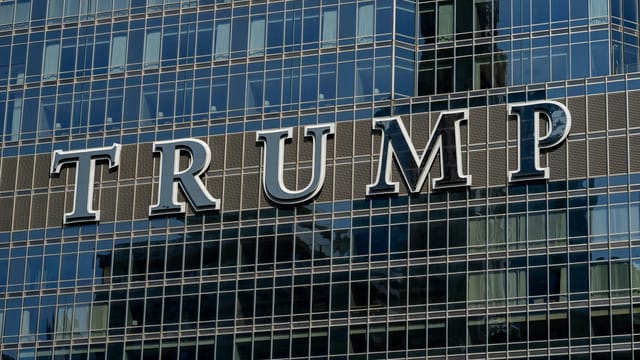Detailed facade view of the Trump building with reflective glass windows.