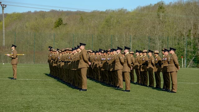 British soldiers standing in formation during a military ceremony at Perham Down, England outdoors.