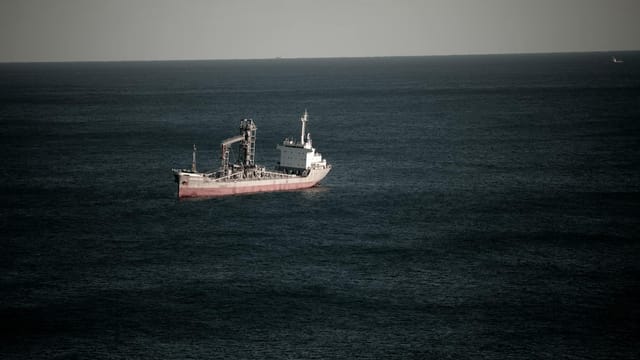Cargo ship navigating in the tranquil waters off the coast of Donghae-si, South Korea.