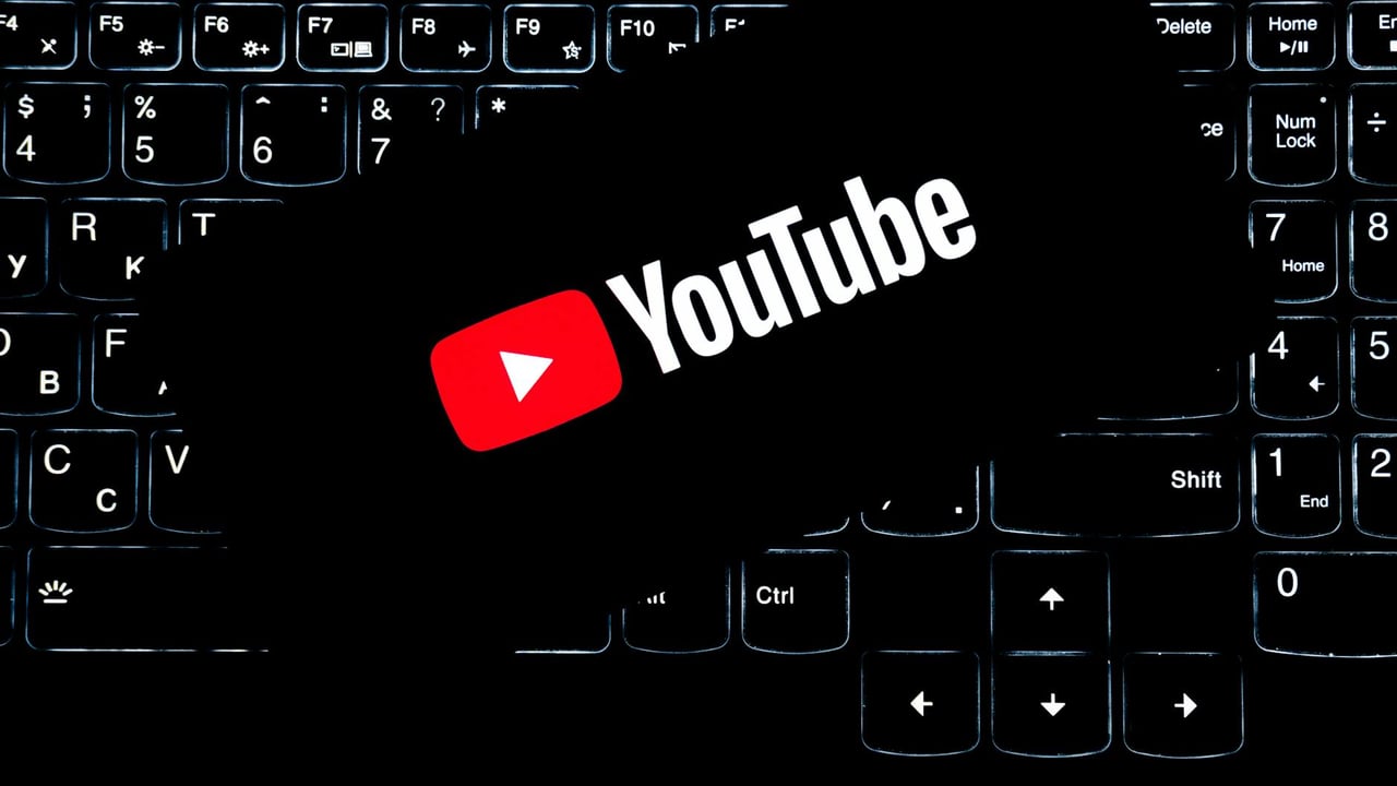 YouTube logo displayed on a backlit keyboard, representing digital media and online content creation.