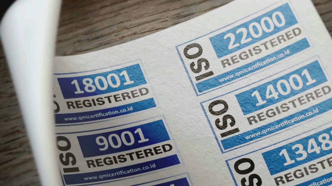 ISO certification stickers with registration numbers on paper.