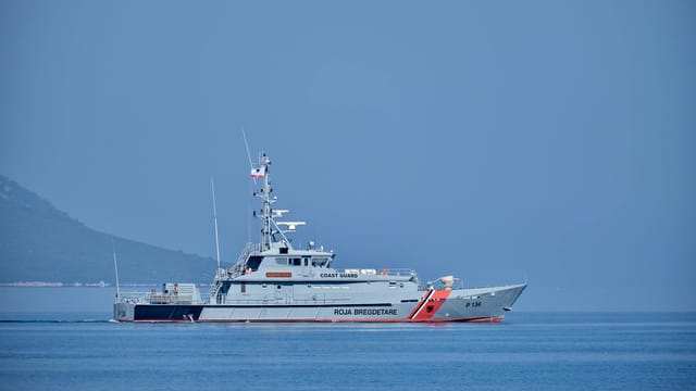 Coast guard vessel patrolling in Vlorë, Albania on a clear day.