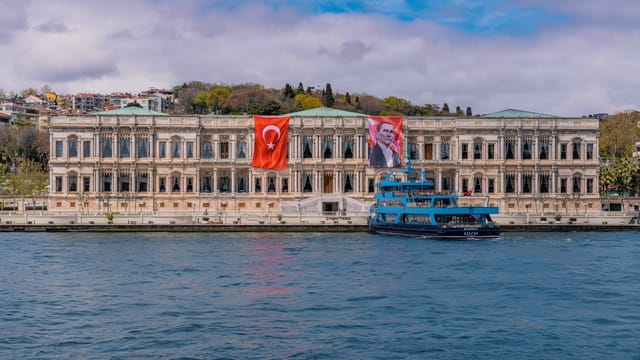 Stunning view of Çırağan Palace and a ferry on the Bosphorus in Istanbul, Turkey.