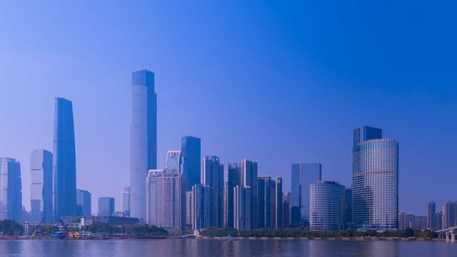 Stunning skyline of Guangzhou featuring skyscrapers and the river at daytime.