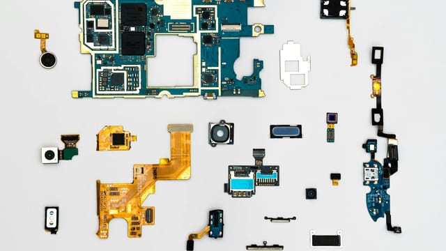 Exploded view of smartphone components showcasing intricate technological design.