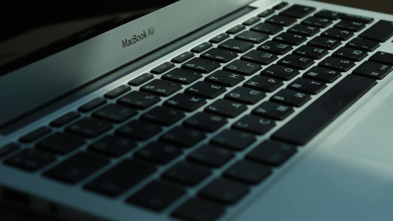 Close-up view of a MacBook Air keyboard with Cyrillic characters, photographed indoors in Jönköping, Sweden.