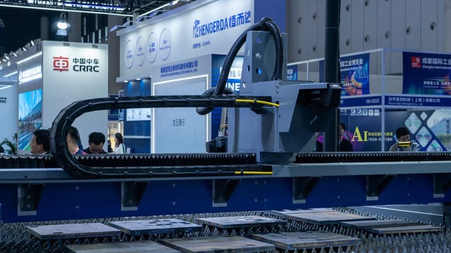A view of advanced industrial machinery displayed at a trade fair exhibit.