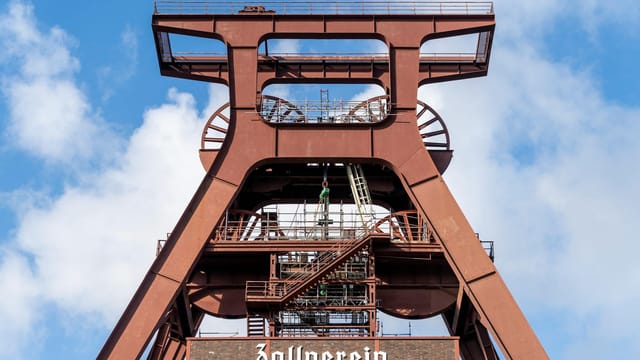 Low angle view of the Zollverein Coal Mine Industrial Complex under clear skies in Essen, Germany.