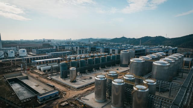 Expansive aerial view of an industrial complex with storage tanks, located in China.