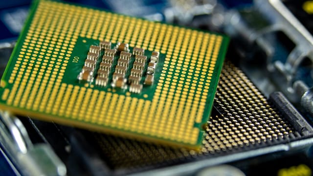 Detailed close-up of a microprocessor on a motherboard showcasing its intricate design.