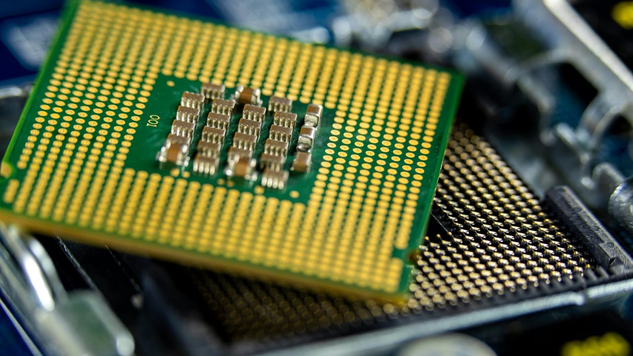Detailed close-up of a microprocessor on a motherboard showcasing its intricate design.