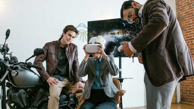 A diverse business team exploring virtual reality technology indoors.