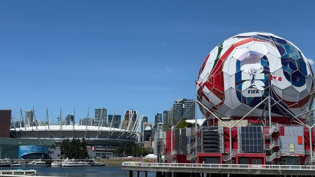 Iconic FIFA soccer ball and Vancouver stadium, showcasing urban sports architecture.