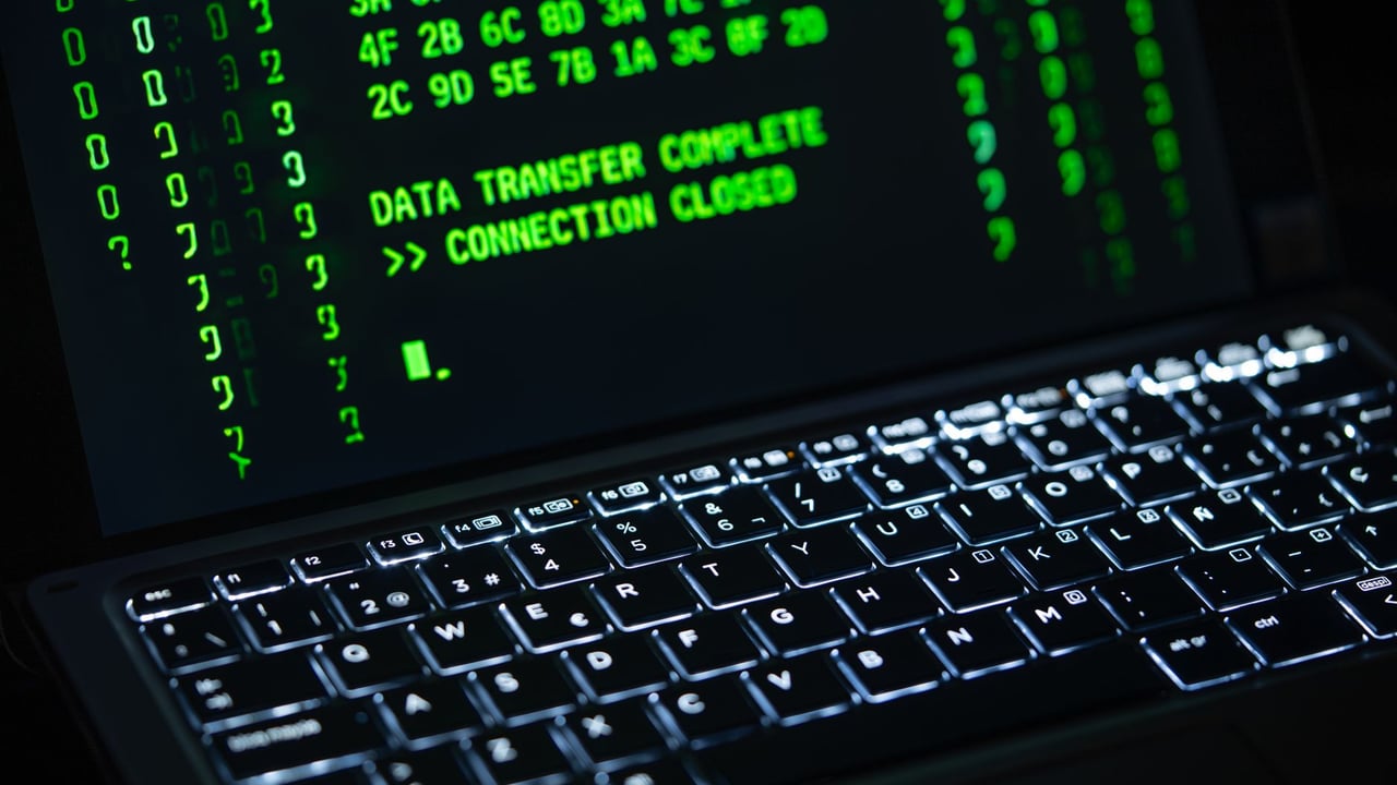 Illustrative image: Close-up of a laptop screen displaying green code text. Perfect for cybersecurity themes.