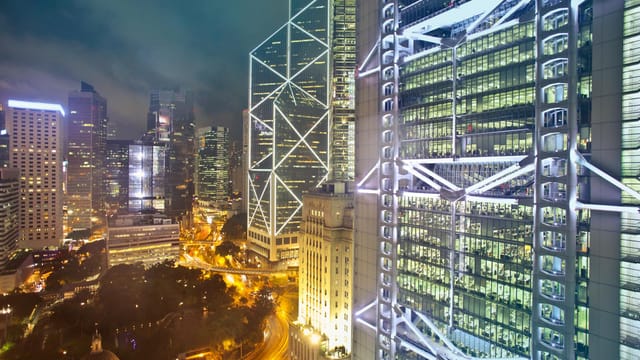 Stunning view of Hong Kong's illuminated skyline featuring modern skyscrapers and bustling city streets.