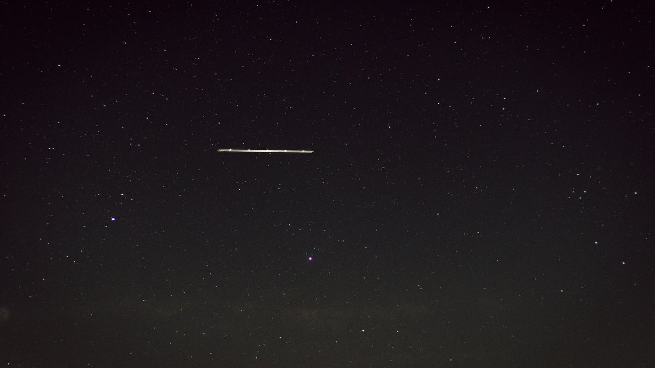 Captivating star-filled night sky with a mysterious line of light, captured in Germany.