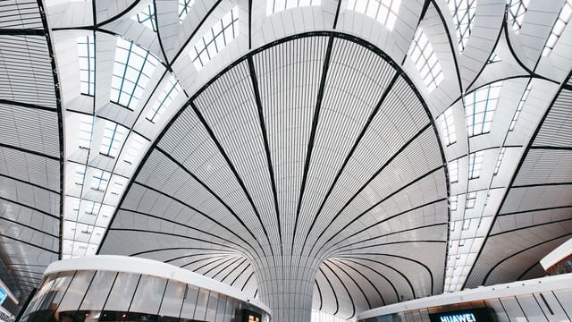 Modern architectural design with curved ceilings in a retail space in Daxing District, Beijing.