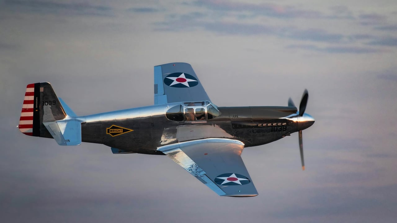 A historic fighter aircraft flying through the sky at sunset, showcasing classic aviation design.