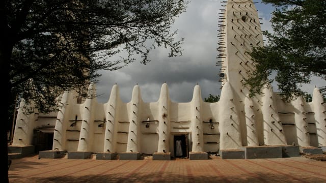 Stunning view of the Grand Mosque in Bobo-Dioulasso, Burkina Faso with dramatic sky.